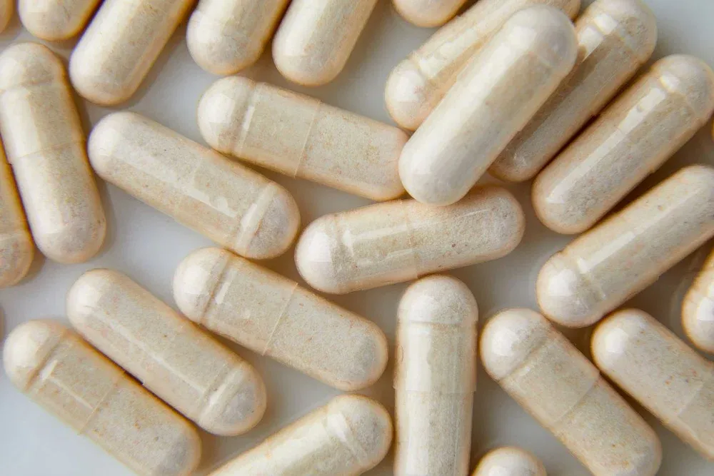 flat lay macro white beige capsule pills tablets